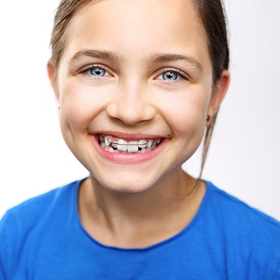 Young girl with orthodontic appliance smiling